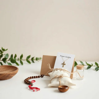 Saint-themed prayer gifts on a neat tabletop with rosary, prayer cards, and pendant.