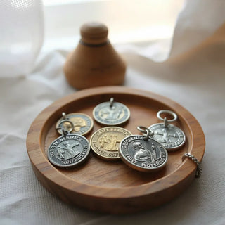 Metal St. Benedict medals on a wooden devotional tray under soft natural light