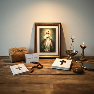 Framed Divine Mercy image with rosary, prayer cards, and devotional items on a wooden table