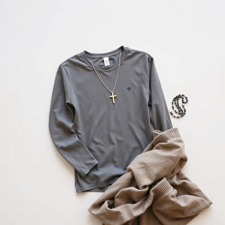 Modest Catholic clothing outfit with a subtle cross necklace and rosary on a neutral background