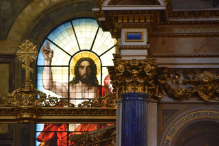 a stained glass window with a picture of jesus on it