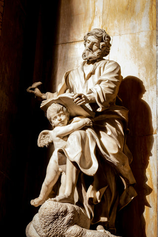 A statue of saint mark with an angel.