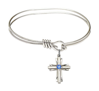 5 3/4 inch Oval Eye Hook Rhodium Bangle Bracelet with a Sterling Silver Cross charm.