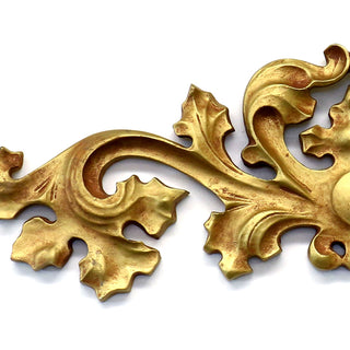 Horizontal fiberglass resin wall carving with a low-relief architectural design. — detail view