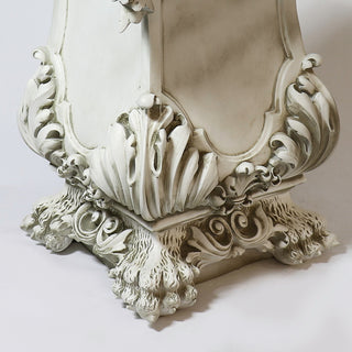 Fiberglass resin pedestal with a draped column design resting on a claw-shaped foot — detail view