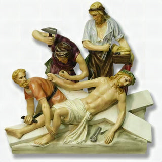 Hand-painted statue depicting Jesus being nailed to the cross, realistic colour finish