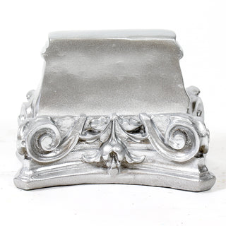 Fluted architectural capital pedestal used as a display base for statues or urns. — alternate view
