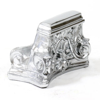 Fluted architectural capital pedestal used as a display base for statues or urns. — alternate view