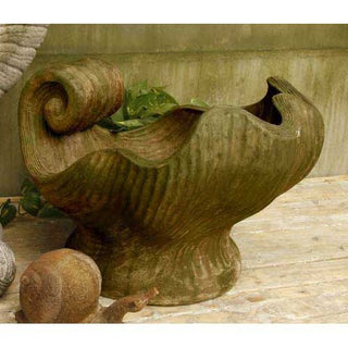 Large sculpted fiberglass resin shell ornament with detailed ridges and spiral curves. — detail view