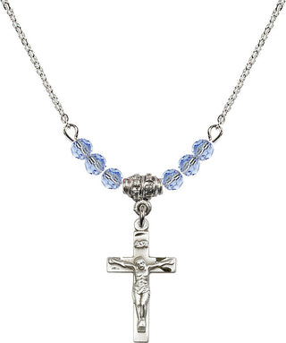 18" Rhodium Plated Necklace with 4mm Light Sapphire Crystal Beads featuring a Sterling Silver Crucifix Medal.