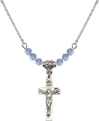 18" Rhodium Plated Necklace with 4mm Light Sapphire Crystal Beads featuring a Sterling Silver Crucifix Medal.