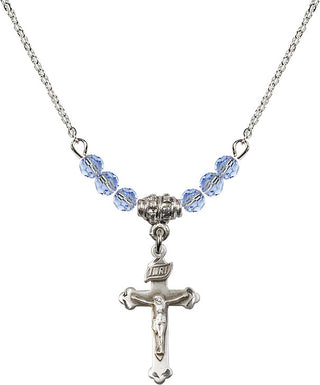 18" Rhodium Plated Necklace with 4mm Light Sapphire Crystal Beads featuring a Sterling Silver Crucifix Medal.