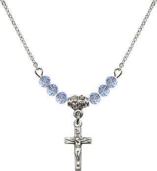 18" Rhodium Plated Necklace with 4mm Light Sapphire Crystal Beads featuring a Sterling Silver Crucifix Medal.