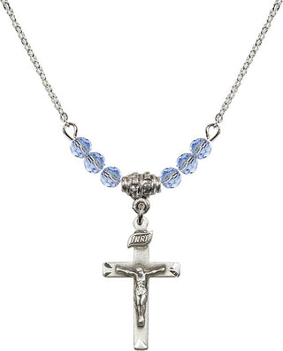 18" Rhodium Plated Necklace with 4mm Light Sapphire Crystal Beads featuring a Sterling Silver Crucifix Medal.