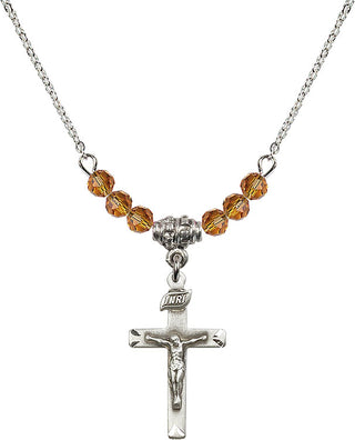 18" Rhodium Plated Necklace with 4mm Topaz Crystal Beads featuring a Sterling Silver Crucifix Medal.