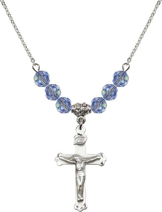 18" Rhodium Plated Necklace with 4mm Light Sapphire Crystal Beads featuring a Sterling Silver Crucifix Medal.
