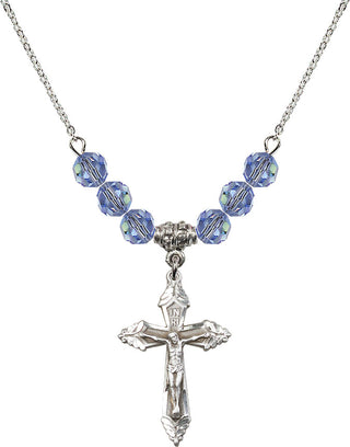 18" Rhodium Plated Necklace with 4mm Light Sapphire Crystal Beads featuring a Sterling Silver Crucifix Medal.