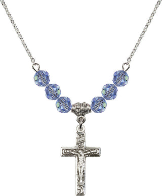 18" Rhodium Plated Necklace with 4mm Light Sapphire Crystal Beads featuring a Sterling Silver Crucifix Medal.