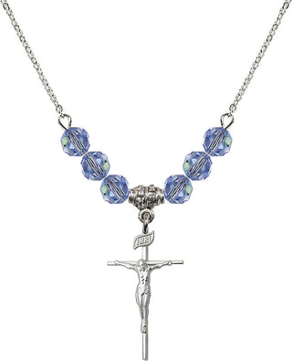 18" Rhodium Plated Necklace with 4mm Light Sapphire Crystal Beads featuring a Sterling Silver Crucifix Medal.