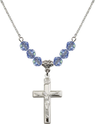 18" Rhodium Plated Necklace with 4mm Light Sapphire Crystal Beads featuring a Sterling Silver Crucifix Medal.