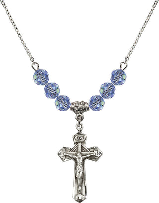 18" Rhodium Plated Necklace with 4mm Light Sapphire Crystal Beads featuring a Sterling Silver Crucifix Medal.