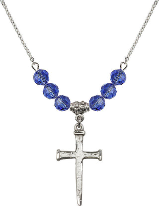 18" Rhodium Plated Necklace with 4mm Sapphire Crystal Beads featuring a Sterling Silver Nail Cross Medal.