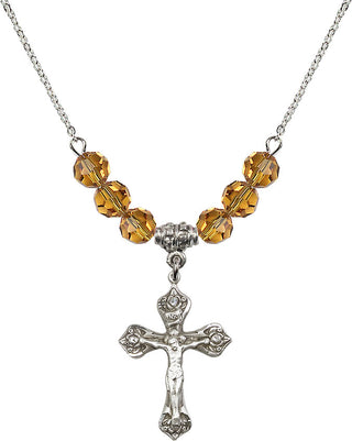18" Rhodium Plated Necklace with 4mm Topaz Crystal Beads featuring a Sterling Silver Crucifix Medal.