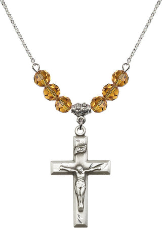 18" Rhodium Plated Necklace with 4mm Topaz Crystal Beads featuring a Sterling Silver Crucifix Medal.