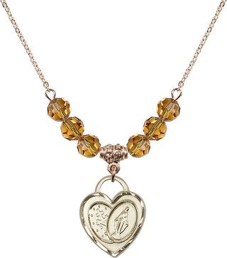 18" Hamilton Gold Plated Necklace with 4mm Topaz Crystal Beads featuring a 14kt Gold Filled Miraculous Heart Medal.