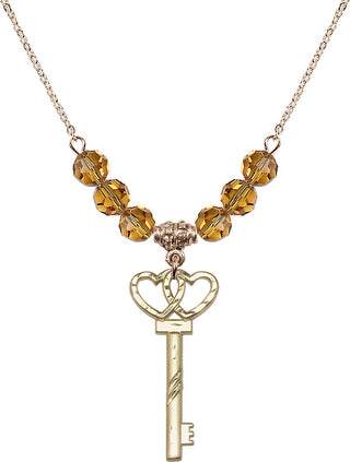 18" Hamilton Gold Plated Necklace with 4mm Topaz Crystal Beads featuring a 14kt Gold Filled Small Key w/Double Hearts Medal.